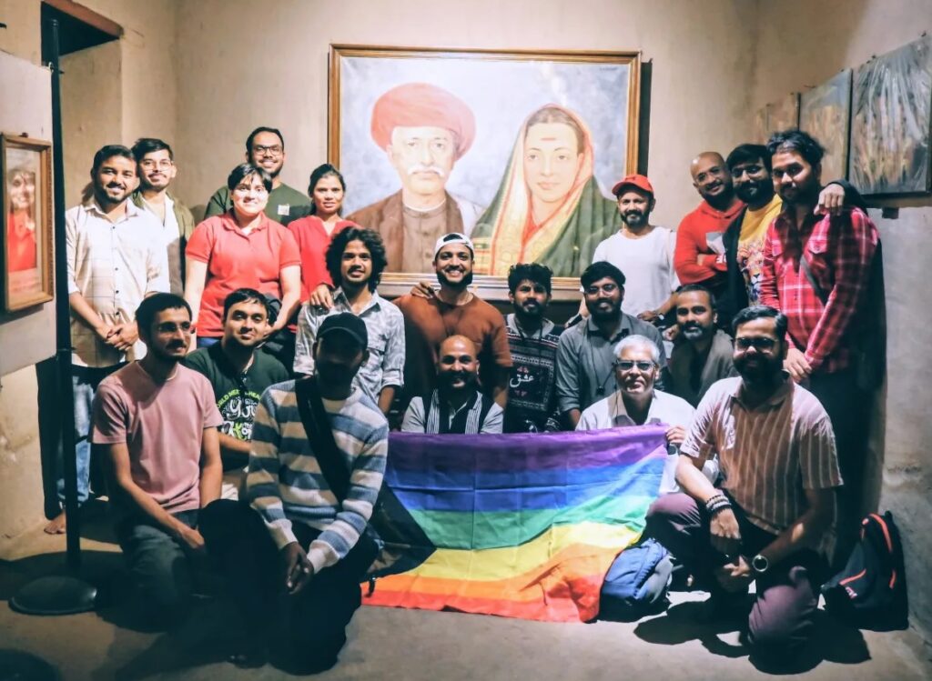 group of people posing with a pride flag and a portrait of Jyotiba & Phule & Savitribai Phule, during Heritage Walk