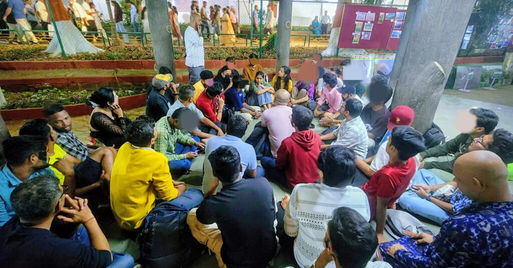 group of people sitting casually in a circle for Q-meet